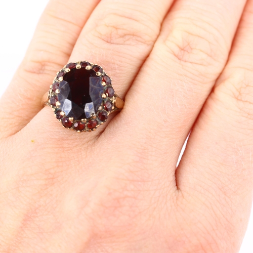 389 - A late 20th century 9ct gold garnet cluster dress ring, setting height 16.6mm, size O, 4.6g