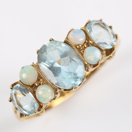 411 - A modern 9ct gold blue topaz and opal half hoop ring, set with oval mixed-cut topaz and round caboch... 