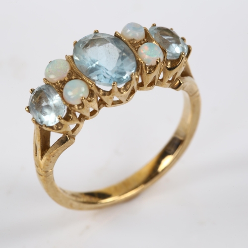 411 - A modern 9ct gold blue topaz and opal half hoop ring, set with oval mixed-cut topaz and round caboch... 