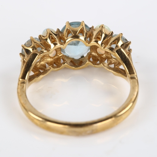 411 - A modern 9ct gold blue topaz and opal half hoop ring, set with oval mixed-cut topaz and round caboch... 