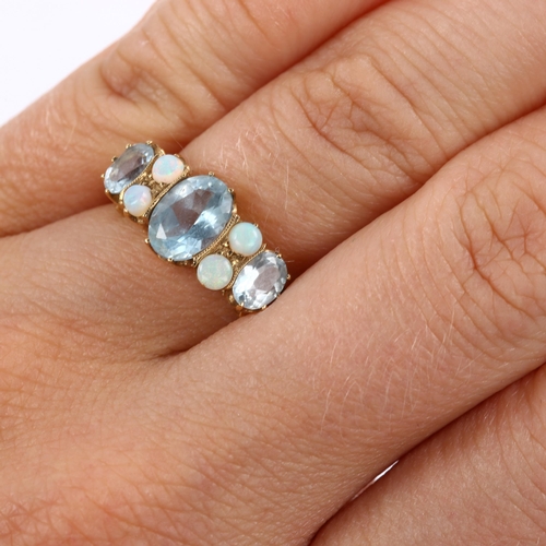 411 - A modern 9ct gold blue topaz and opal half hoop ring, set with oval mixed-cut topaz and round caboch... 