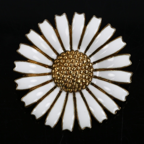 457 - GEORG JENSEN - a Danish vermeil sterling silver and white enamel daisy pattern brooch, diameter 32.5... 