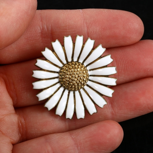 457 - GEORG JENSEN - a Danish vermeil sterling silver and white enamel daisy pattern brooch, diameter 32.5... 