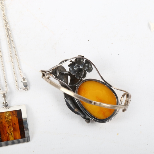 487 - An Austrian silver and butterscotch amber floral bracelet, and a silver and specimen amber pendant n... 