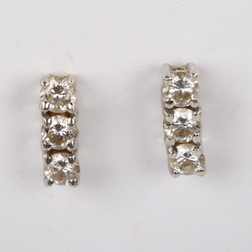 488 - A pair of three stone diamond earrings, unmarked gold settings with stud fittings and modern round b... 