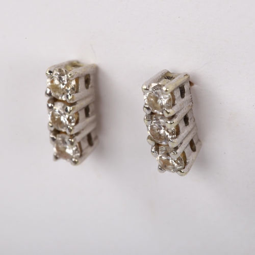 488 - A pair of three stone diamond earrings, unmarked gold settings with stud fittings and modern round b... 