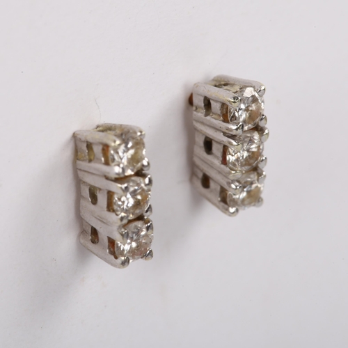 488 - A pair of three stone diamond earrings, unmarked gold settings with stud fittings and modern round b... 