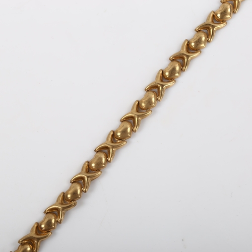 490 - A 9ct gold heart and cross bracelet, length 18cm, 4.1g