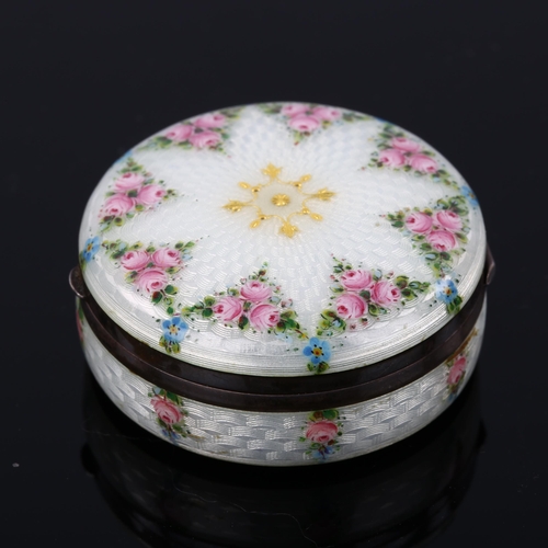 503 - A Swedish silver and enamel circular box, hand painted rose and pansy decoration with guilloche turn... 