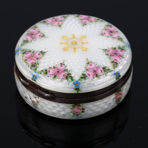 503 - A Swedish silver and enamel circular box, hand painted rose and pansy decoration with guilloche turn... 