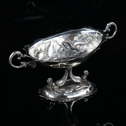 513 - A 19th century Spanish silver pedestal table salt, with relief embossed fish decoration and mermaid ... 