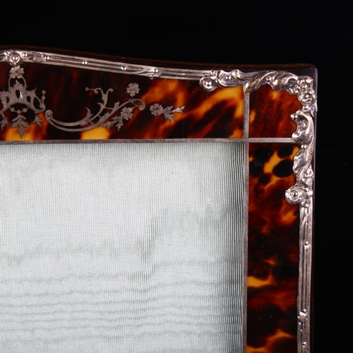 517 - An Edwardian tortoiseshell photo frame, with unmarked silver mounts, overall height 26cm, internal m... 