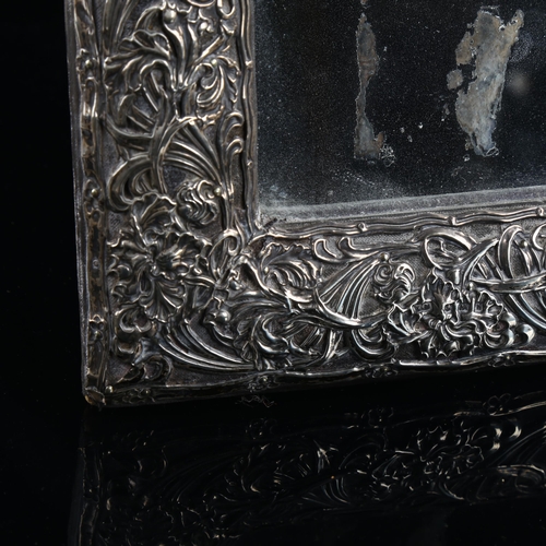 518 - A large Edwardian silver-fronted rectangular dressing table strut mirror, embossed floral decoration... 