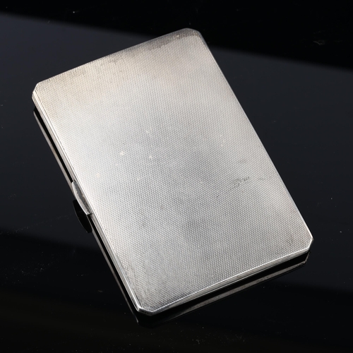 530 - A George VI silver cigarette case, allover engine turned decoration with gilt interior, by E J Trevi... 