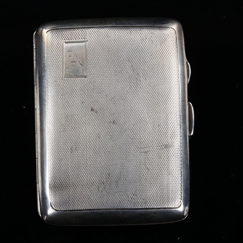 532 - An Art Deco George VI curved silver cigarette case, allover engine turned decoration with gilt inter... 