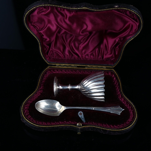 537 - A Victorian silver egg cup and spoon set, twisted fluted decoration, indistinct maker's marks, hallm... 