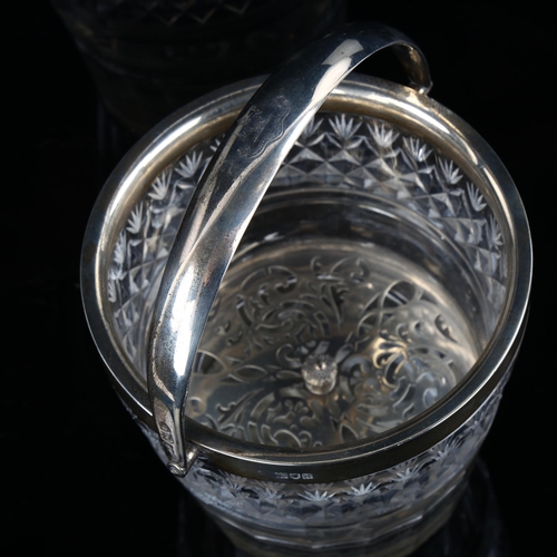 540 - A George V silver-mounted glass ice bucket, with swing handle and pierced liner, armorial crest on h... 