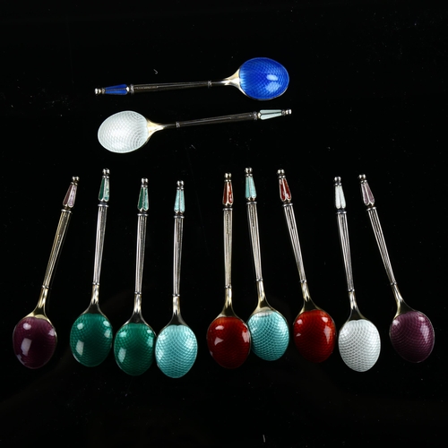 560 - ANTON MICHELSEN - a set of 11 Danish vermeil sterling silver and harlequin enamel coffee spoons, wit... 