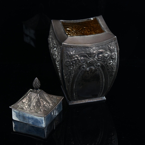 579 - A Victorian silver tea caddy, shaped square form with relief embossed floral decoration and flame fi... 