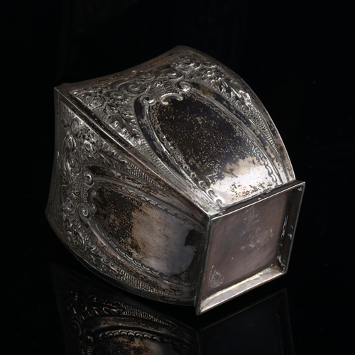 579 - A Victorian silver tea caddy, shaped square form with relief embossed floral decoration and flame fi... 