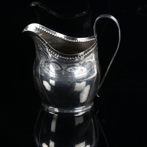 580 - A George III silver helmet-shape cream jug, with bright-cut engraved decoration, indistinct maker's ... 