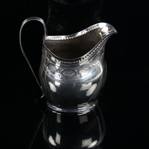 580 - A George III silver helmet-shape cream jug, with bright-cut engraved decoration, indistinct maker's ... 