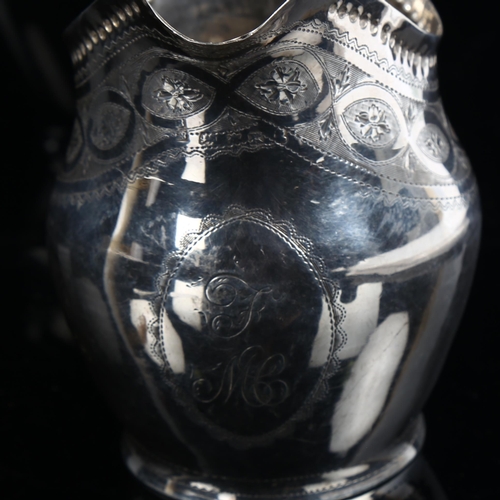 580 - A George III silver helmet-shape cream jug, with bright-cut engraved decoration, indistinct maker's ... 