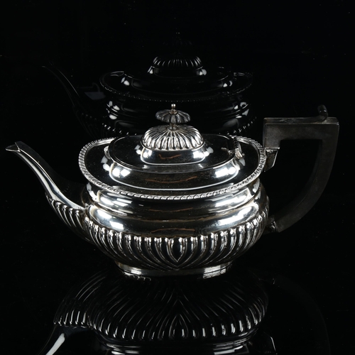 582 - An Edward silver teapot, oval bulbous form with half fluted decoration and ebonised mounts, by Willi... 