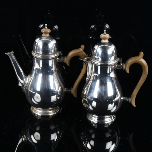 585 - A pair of George VI sliver coffee and hot water jugs, baluster form with turned wood mounts, by Mapp... 