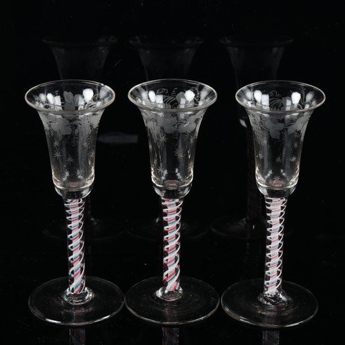 1121 - A set of 3 x 18th/19th century cordial glasses, with multicolour twist stems and engraved vine bowls... 