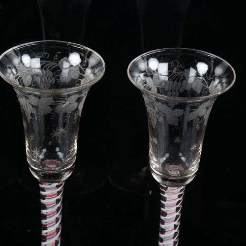 1121 - A set of 3 x 18th/19th century cordial glasses, with multicolour twist stems and engraved vine bowls... 