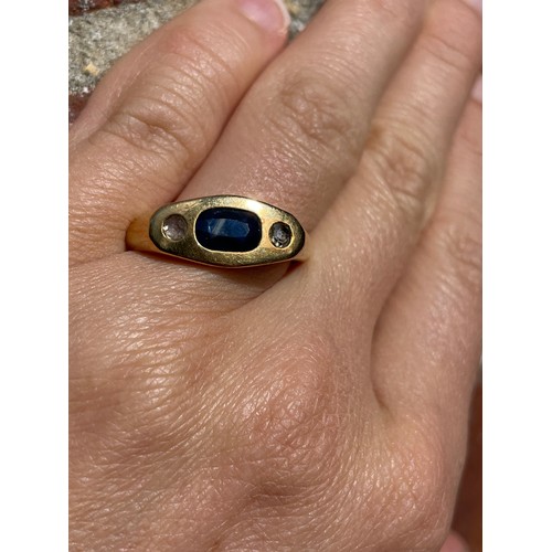 268 - A heavy three stone sapphire and diamond ring, unmarked gold settings with oval mixed-cut sapphire a... 