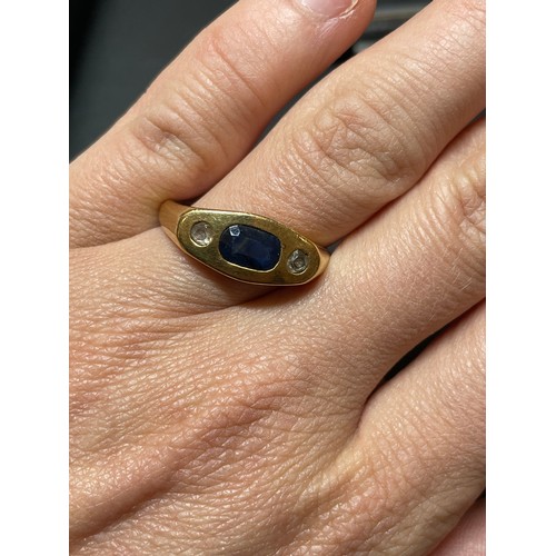 268 - A heavy three stone sapphire and diamond ring, unmarked gold settings with oval mixed-cut sapphire a... 