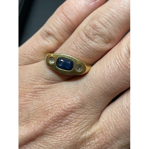 268 - A heavy three stone sapphire and diamond ring, unmarked gold settings with oval mixed-cut sapphire a... 