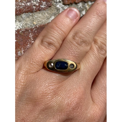 268 - A heavy three stone sapphire and diamond ring, unmarked gold settings with oval mixed-cut sapphire a... 