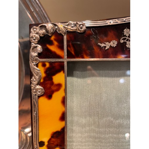 517 - An Edwardian tortoiseshell photo frame, with unmarked silver mounts, overall height 26cm, internal m... 