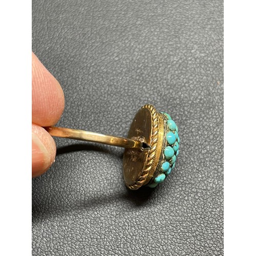 170 - An Antique turquoise bombe ring, unmarked gold settings with round cabochon turquoise and rope twist... 