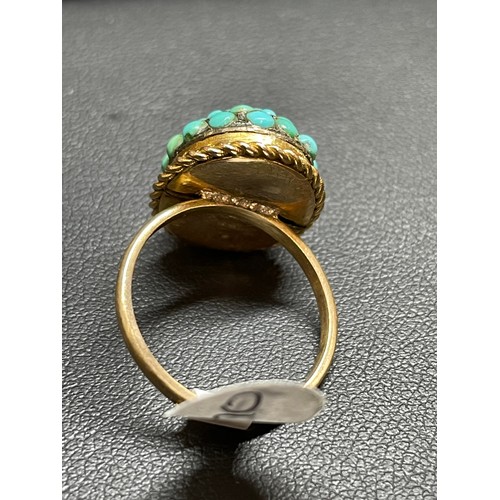 170 - An Antique turquoise bombe ring, unmarked gold settings with round cabochon turquoise and rope twist... 