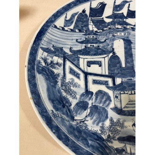 1142 - A Chinese blue and white porcelain charger, with hand painted palace fortifications, diameter 37cm