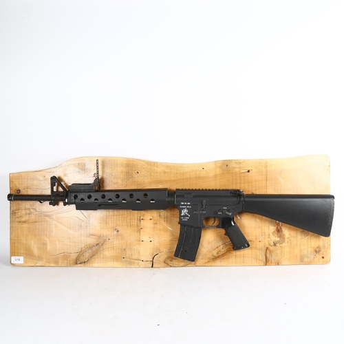 518 - Clive Fredriksson, Stoner rifle mounted on wood, 29cm x 99cm