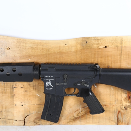 518 - Clive Fredriksson, Stoner rifle mounted on wood, 29cm x 99cm