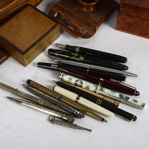 542 - A box of desk items, including copper inkstand, pug work blotter, fountain pens etc