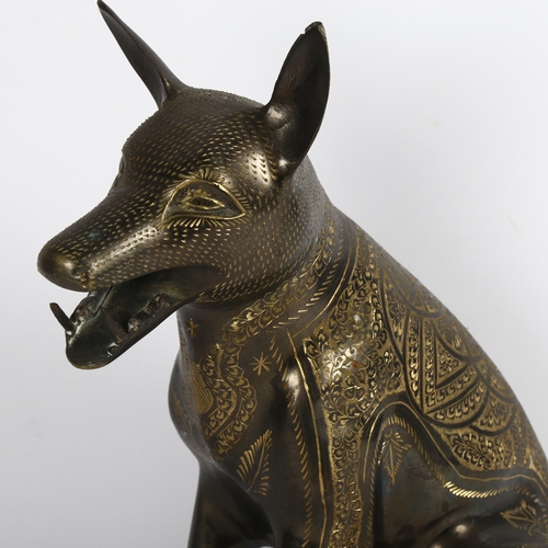 543 - An Egyptian cast-brass jackal with engraved decoration, height 34cm