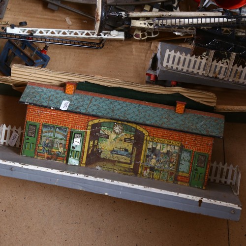 523 - Hornby tin train station and signal boxes, including water tank and various accessories