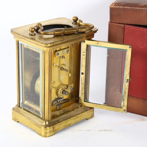 146 - A French brass-cased carriage clock, with bevelled-glass panel, 8-day movement, with original carryi... 