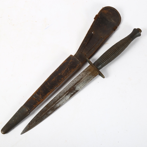 151 - A World War II Commando fighting knife, with ribbed handle and leather sheath, length 29.5cm