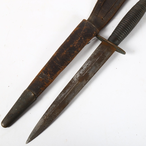 151 - A World War II Commando fighting knife, with ribbed handle and leather sheath, length 29.5cm