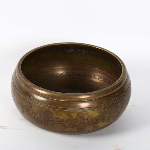 156 - A Tibetan brass singing bowl, with 5 Dhyani embossed internal decoration and engraved body, width 13... 