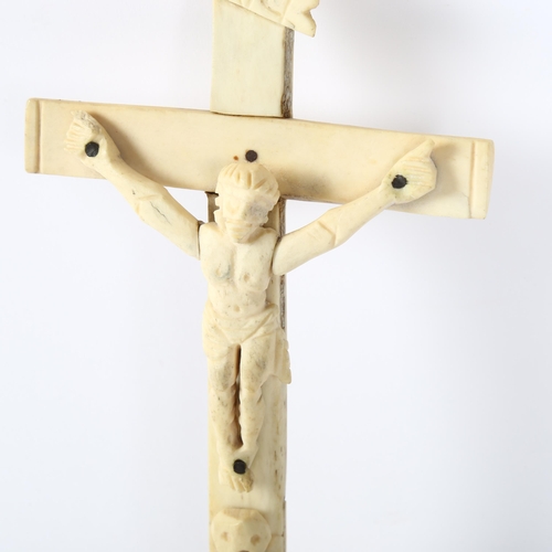 166 - An 18th century carved bone crucifix, length 22cm