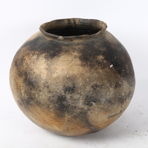 169 - A large African pottery cooking pot, height 20cm